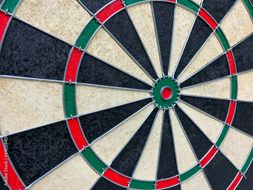 Close up view to the dartboard game with focus to the red bulls eye. Representing success and business target meaning. Empty board without darts.