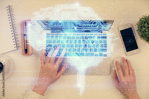 Double exposure of woman working on computer andhuman brain hologram drawing. Top View. Ai concept.
