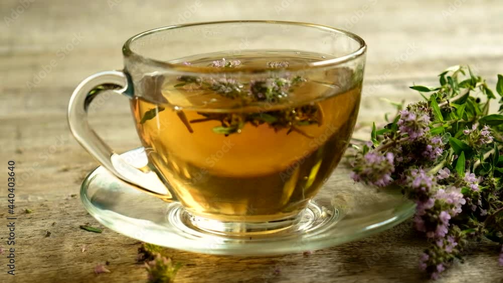 Tea with thyme in a transparent cup. Selective focus. Tea with thyme in a transparent cup. Selective focus.