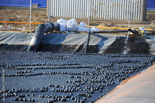 East Kazakhstan region, Kazakhstan - 12.02.2015 : The chemical tank is covered with plastic balls to slow evaporation at the copper cathode mining plant. photo