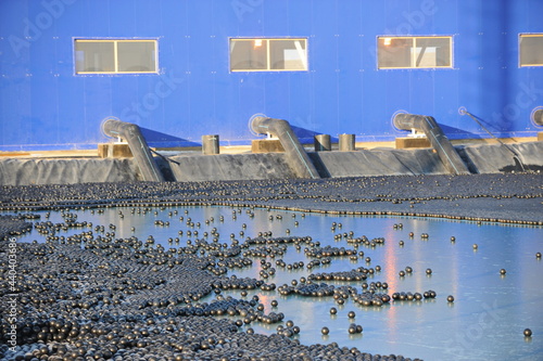 East Kazakhstan region, Kazakhstan - 12.02.2015 : The chemical tank is covered with plastic balls to slow evaporation at the copper cathode mining plant. photo