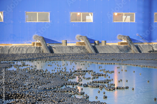 East Kazakhstan region, Kazakhstan - 12.02.2015 : The chemical tank is covered with plastic balls to slow evaporation at the copper cathode mining plant. photo