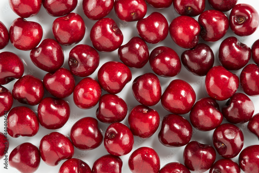 Red cherries on white, design for backgrounds and textures Red cherries on white, design for backgrounds and textures