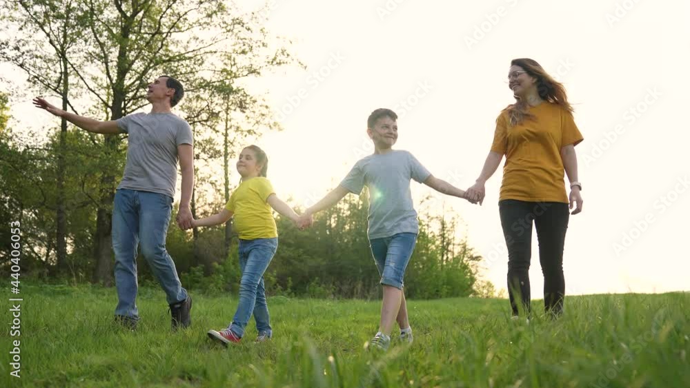 Happy family in park. Group of people walk in field. Parents and children walk in park. Family dream. Happy people in park. Children dream in park. Happy family concept. Cheerful children are walking. Happy family in park. Group of people walk in field. Parents and children walk in park. Family dream. Happy people in park. Children dream in park. Happy family concept. Cheerful children are walking.