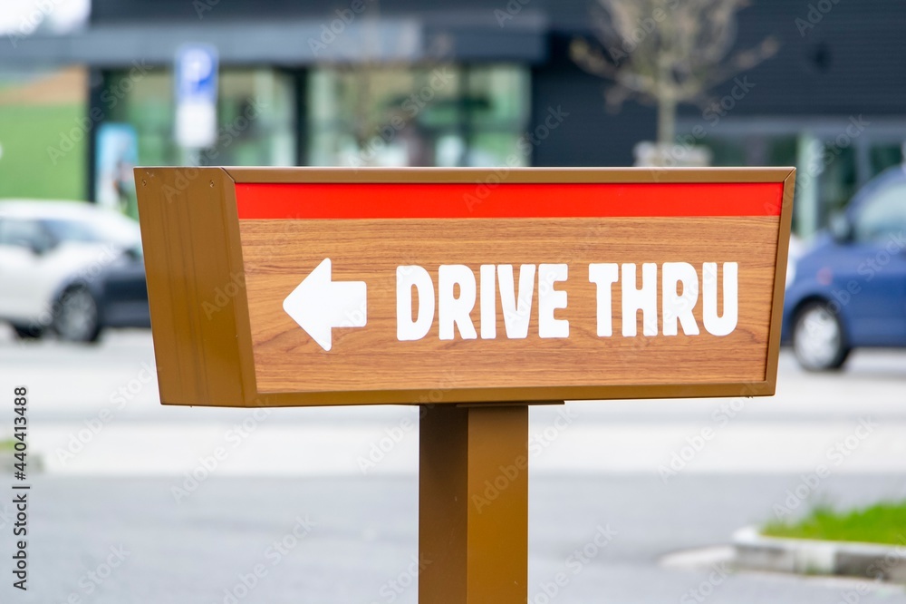 Drive Thru sign near a fast food restaurant showind the direction for