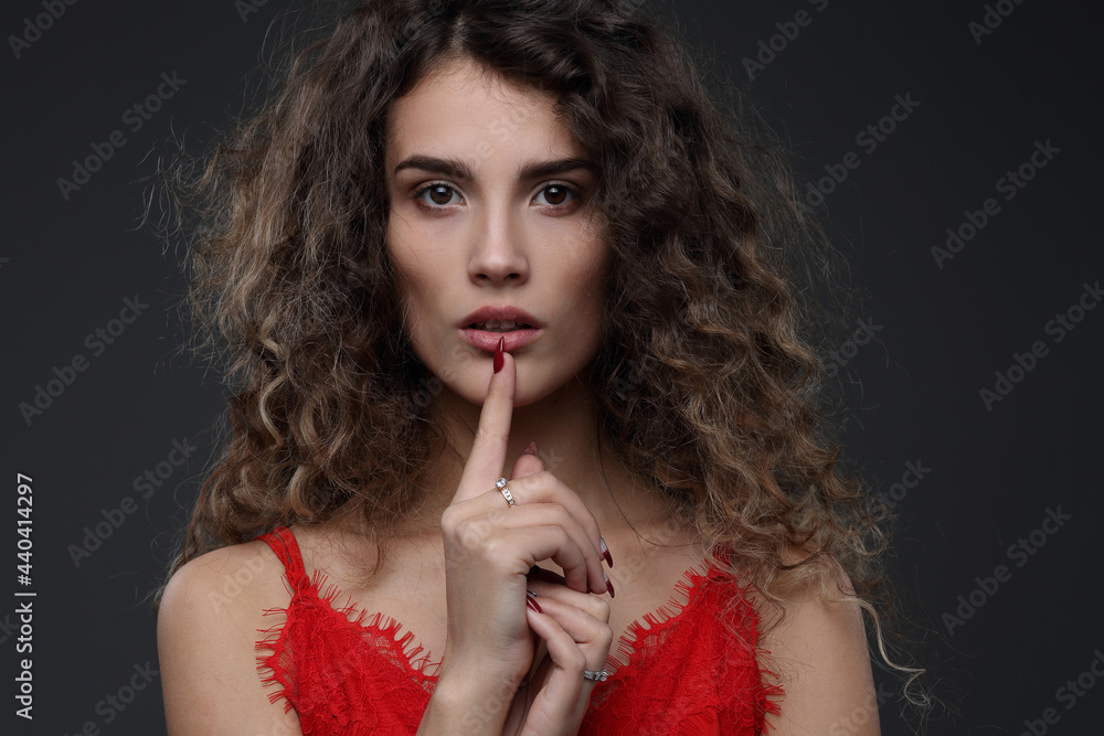 Beautiful girl in a red blouse on a dark background Beautiful girl in a red blouse on a dark background