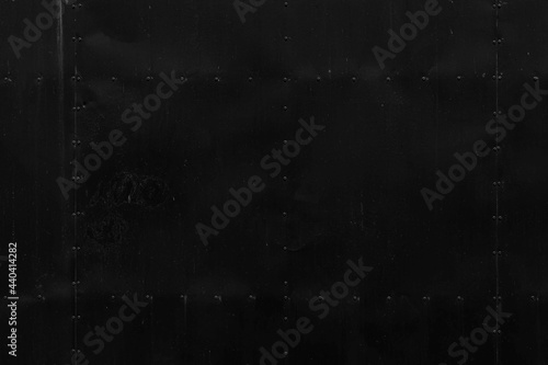 Antique Black iron door wall with rivets pattern and background seamless