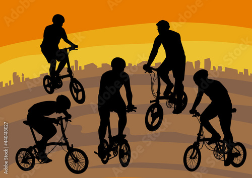 silhouette image of people playing folding bike