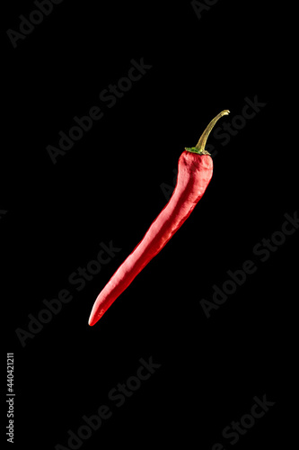 Red jalapeno. Spicy chile cayenne pepper isolated. Red hot chili paprika on black background. Fresh spice vegetable concept.