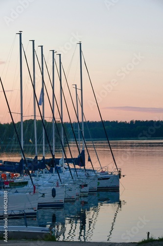 Fototapeta Naklejka Na Ścianę i Meble -  Sailboats at sunset, in the port, ready for next day regatta.