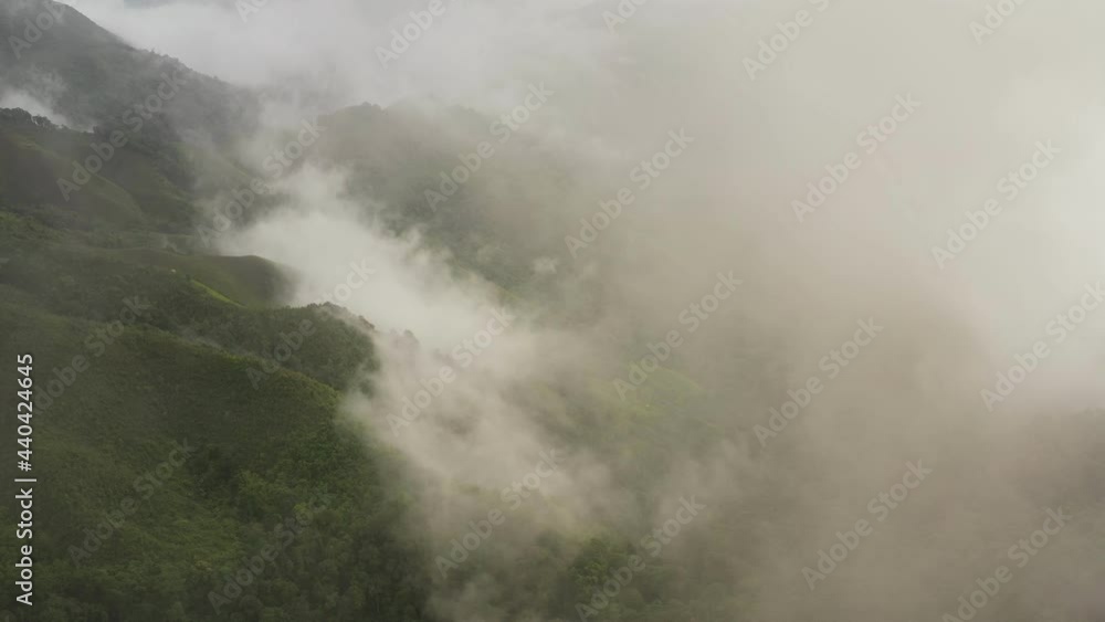 Aerial view flying above lush green tropical rain forest mountain with rain cloud cover during the rainy season on the Doi Phuka Mountain reserve national park. In, the northern Thailand Aerial view flying above lush green tropical rain forest mountain with rain cloud cover during the rainy season on the Doi Phuka Mountain reserve national park. In, the northern Thailand