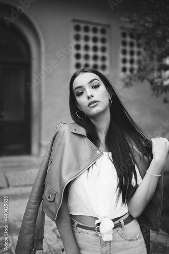 Beautiful young woman posing in front of apartment building dressed casually © alexandermils