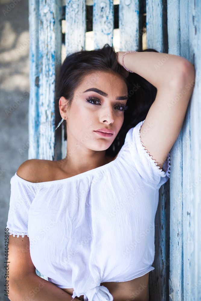 Fototapeta premium Beautiful young woman spending some time at the park and lying on the bench. Top View