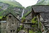 the famous village of Foroglio in Ticino, Switzerland. With the houses built by rocks and the waterfall in the background on a rainy day in May