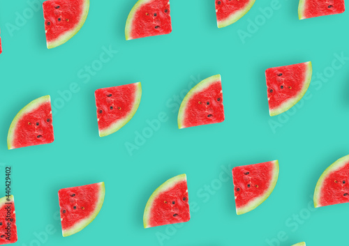 Fresh watermelon slice pattern on a green background repeating. Summer fruit. Top view. 
