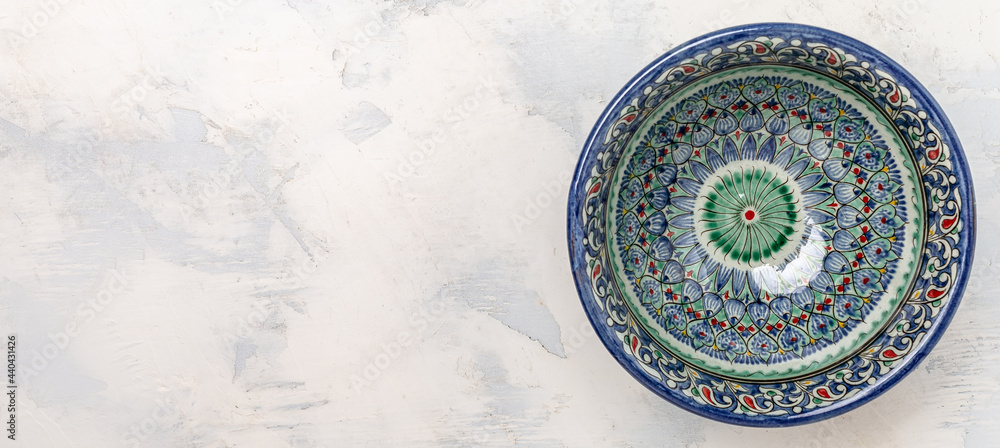 traditional Uzbek utensils with national floral ornament. Ethnic Uzbek ceramic dish. Asian style