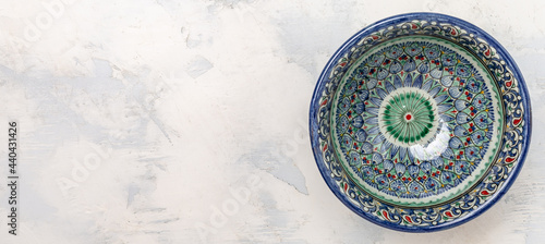 traditional Uzbek utensils with national floral ornament. Ethnic Uzbek ceramic dish. Asian style