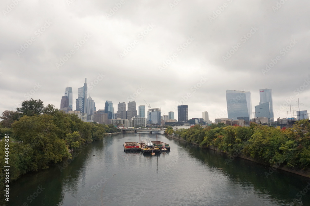 View of Skyscrapers in Center City and Barges on River on Overcast Day