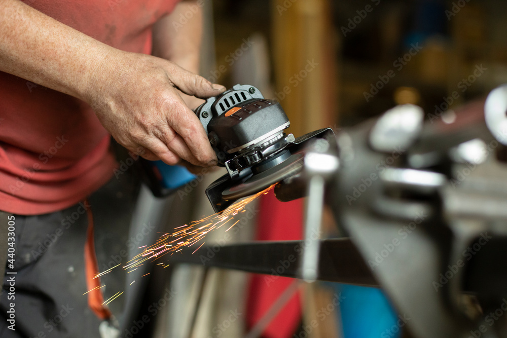 A man works in a garage. A man works in a garage.