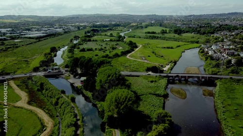 Flying over the Exeter shipping canal and the river Exe towards countess wear bridge and swing bridge in summer
