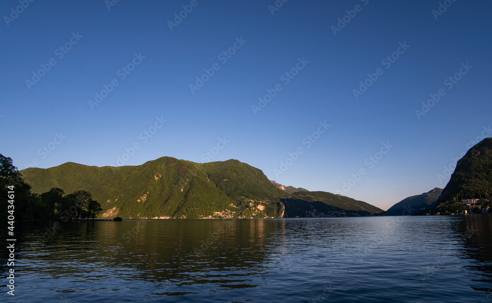 idillc view of Lake Lugano in Ticino Switzerland on a beautiful day without any clouds in the sky