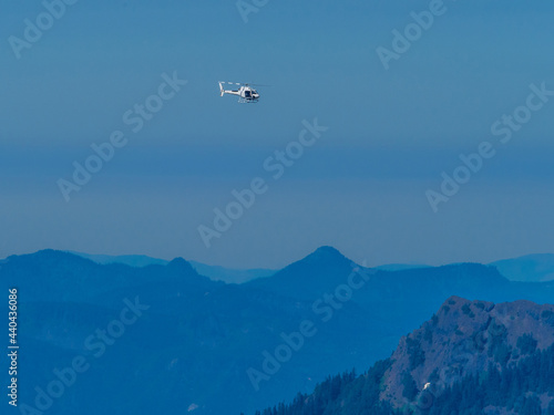 Helicopter flying above mountains