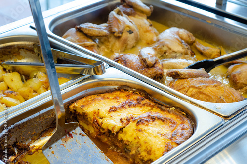 Layered moussaka with potatoes and chickens in a buffet bain containers Fototapeta