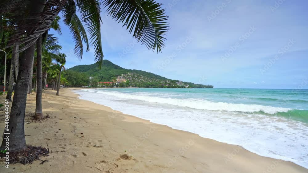 Amazing Beach in the phuket island with coconut trees in tropical beaches of Phuket Thailand on a sunny summer day Overlooking the horizon with waves crashing toward sandy shore Nature background Amazing Beach in the phuket island with coconut trees in tropical beaches of Phuket Thailand on a sunny summer day Overlooking the horizon with waves crashing toward sandy shore Nature background