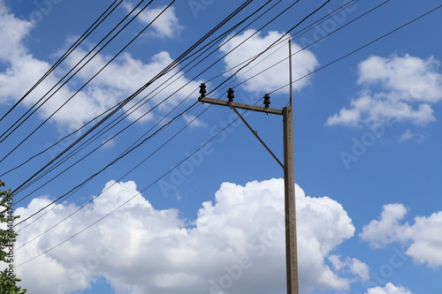Wallpaper Mural Electricity high voltage system, electric pole, transmission line, insulator supporting, isolated on blue sky and white cloud background closeup. Torontodigital.ca