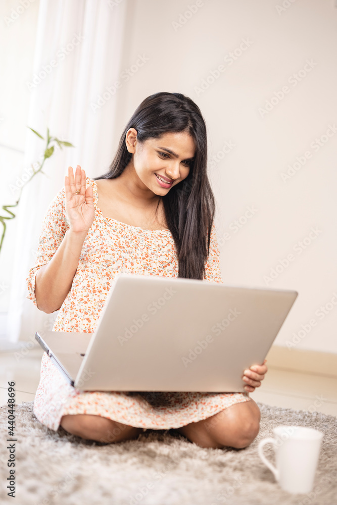 Indian pretty young girl talking in webcam in laptop at home