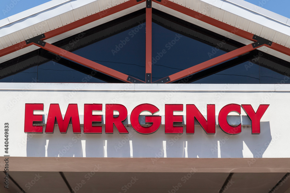 Emergency Entrance sign in bold red text for a local hospital. Emergency Entrance sign in bold red text for a local hospital.