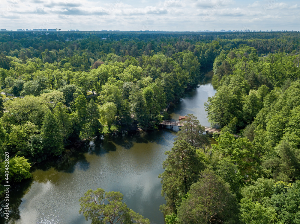 Obraz premium Lake in the coniferous forest in spring. Aerial drone view.