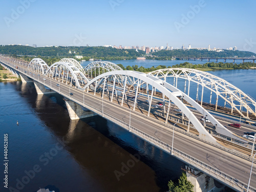 Darnitsky bridge in Kiev in sunny weather. Aerial drone view.