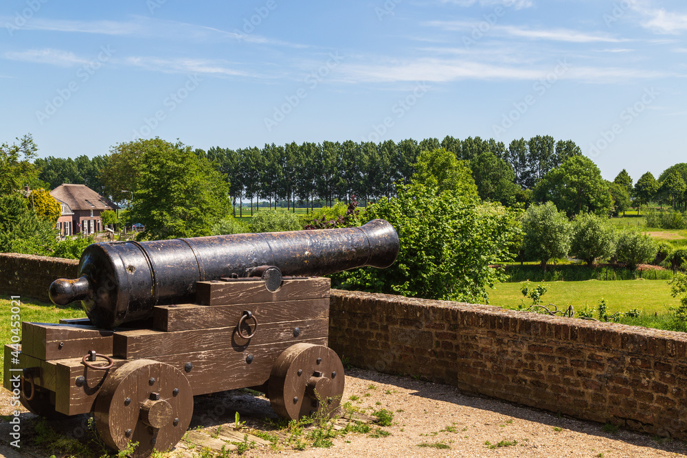 Old cannon on the ramparts on the edge of the old picturesque fortified town of Buren in the province of Gelderland.