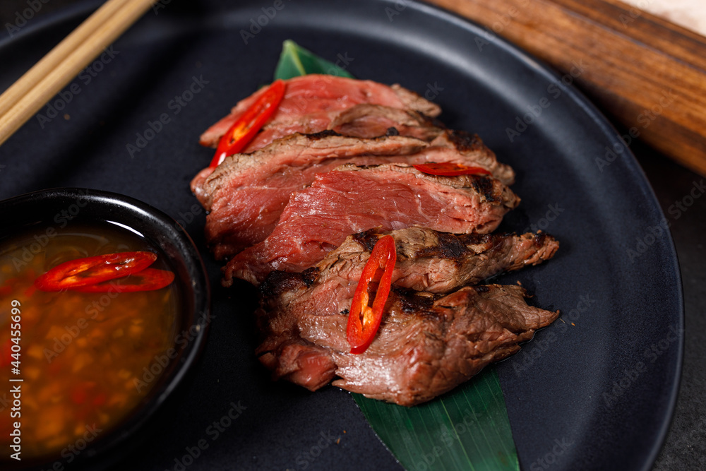 Beef tataki served on hot salt with sauce Beef tataki served on hot salt with sauce
