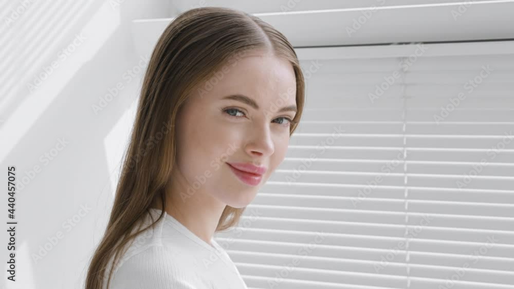 Beautiful young woman happy teeth smile face portrait looking camera, beautiful model with long brunette hair white color window Beautiful young woman happy teeth smile face portrait looking camera, beautiful model with long brunette hair white color window