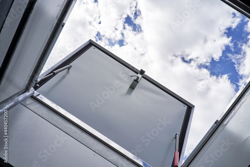 open hatch for roof access cloudy sky on background