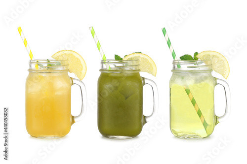 Summer iced green teas in mason jar glasses isolated on a white background. Iced green tea lemonade, iced matcha lemonade and iced green tea.