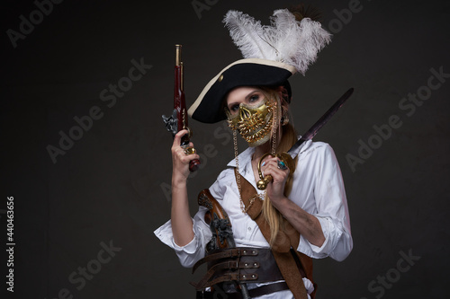 Female buccaneer with mask against dark background