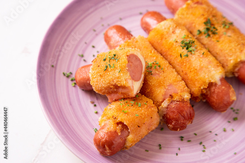 Flamenquines. Traditional Spanish tapa. Breaded sausage wrapped with ham and cheese. photo