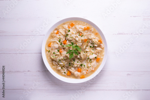 Soupy rice with cod, carrot and artichokes. Traditional Spanish tapa.
