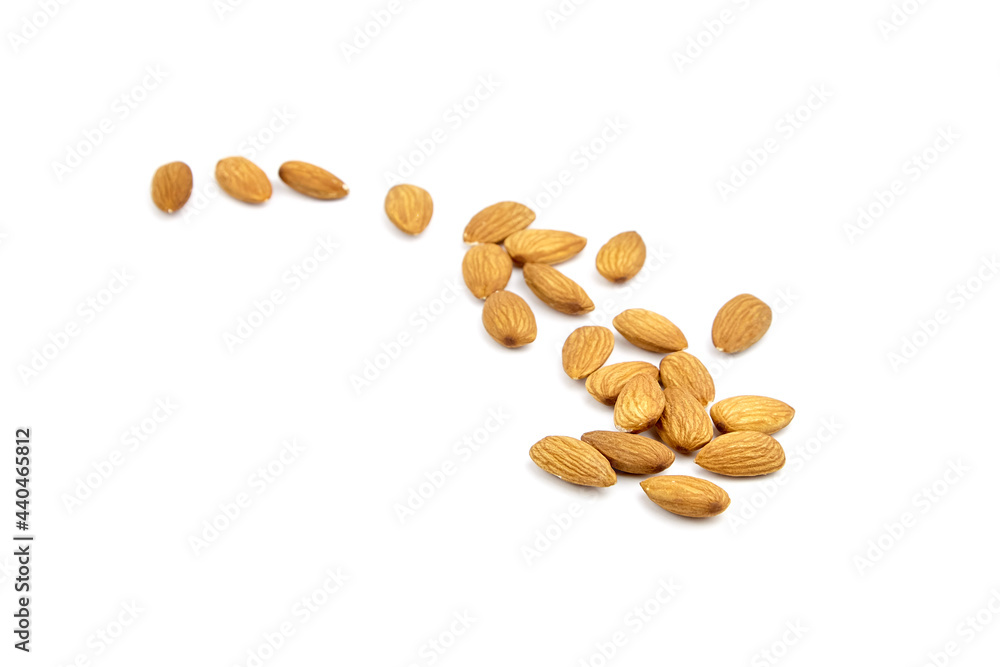 Almond nuts isolated on white background. Heap of scattered almonds Almond nuts isolated on white background. Heap of scattered almonds