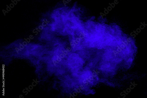 Blue color dust particles splash on black background.