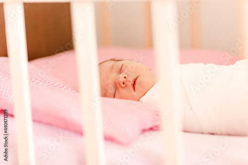 Newborn baby sleeps in crib