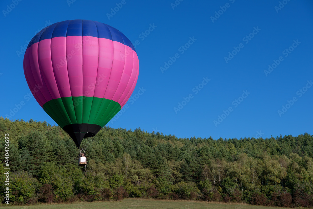 Obraz premium Multicoloured hot air balloon in the sky on a beautiful summer morning on the Balloon festival.