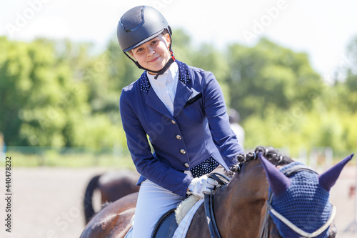 Happy teenage rider girl after her dressage test