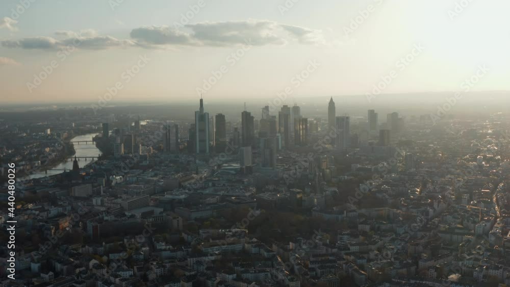 Aerial view of tall modern buildings downtown from slowly backwards flying drone. Cityscape with skyscrapers against bright sky. Frankfurt am Main, Germany Aerial view of tall modern buildings downtown from slowly backwards flying drone. Cityscape with skyscrapers against bright sky. Frankfurt am Main, Germany