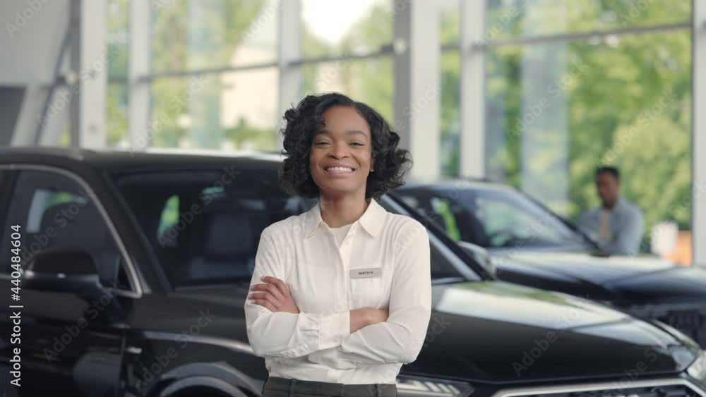 Auto dealer keeping hands crossed and smiling sincerely Auto dealer keeping hands crossed and smiling sincerely