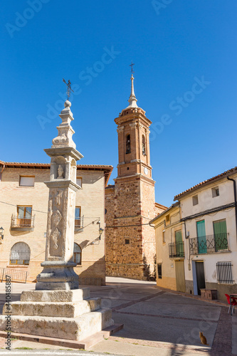 Peiron/humilladero of San Anton (tiny Christian chapel on top of a column) at the Spain Square and the church of El Salvador in Tornos, province of Teruel, Aragon, Spain