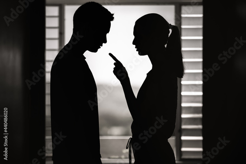 Young wife woman nagging her husband. Bad relationship, jealousy, frustration concept.   photo